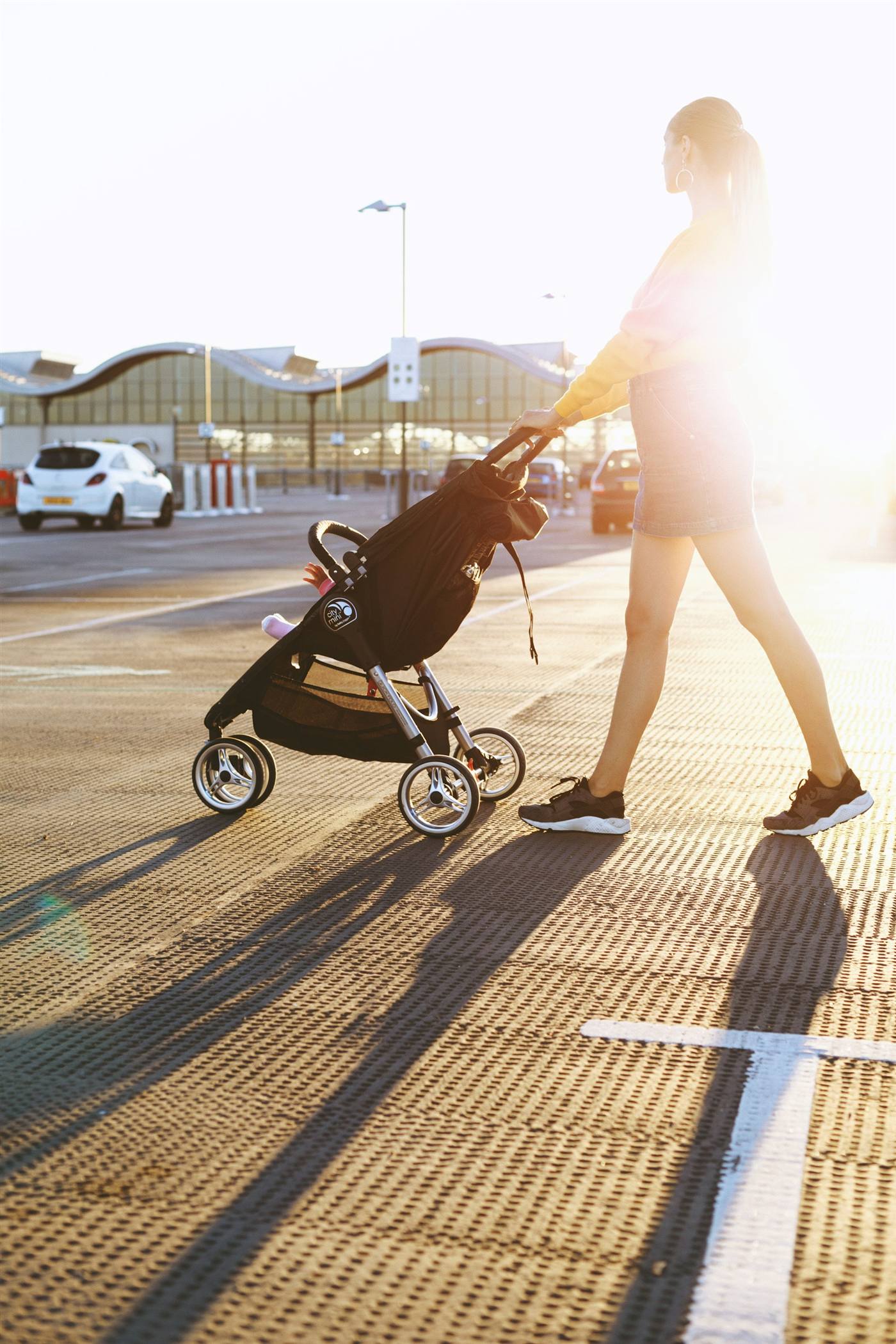 Parent pushing a baby stroller while browsing trusted Canadian baby gear retailers